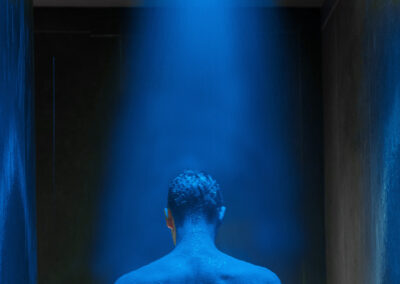 Man under Low lit spa LED colour shower