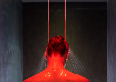 Man under Low lit spa LED colour shower