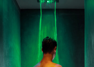 Man under Low lit spa LED colour shower